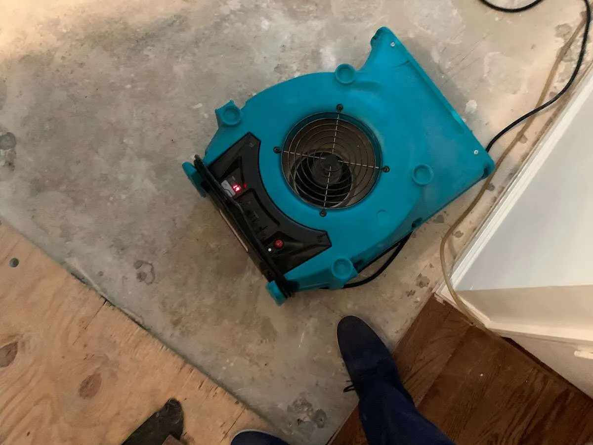 Air mover drying subfloor during Commercial Water Damage Restoration in Lake Norman of Catawba